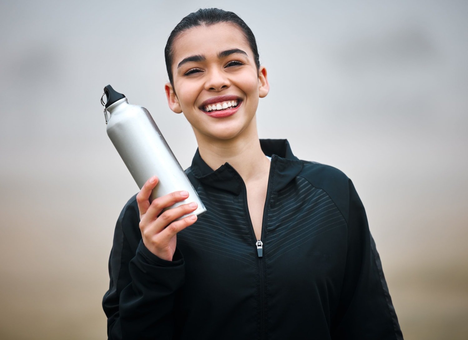 woman holding metal water bottle