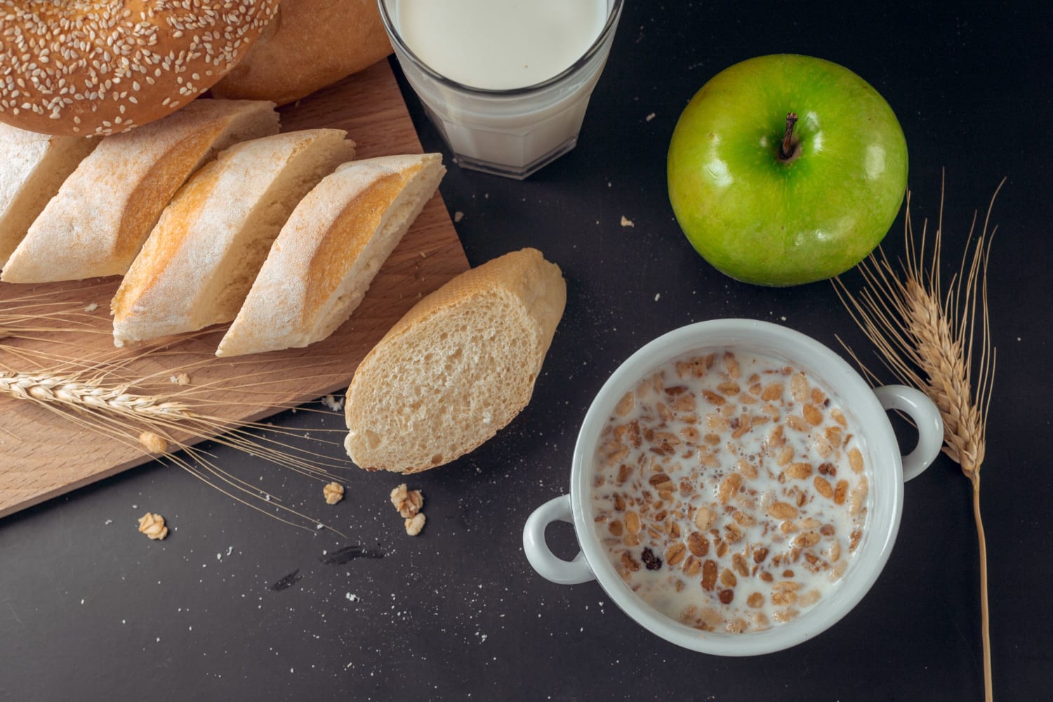 white bread, cereal, and a green apple
