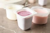 pots of fruit yogurt in white cartons