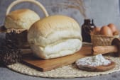 white loaf of bread on a wooden chopping board