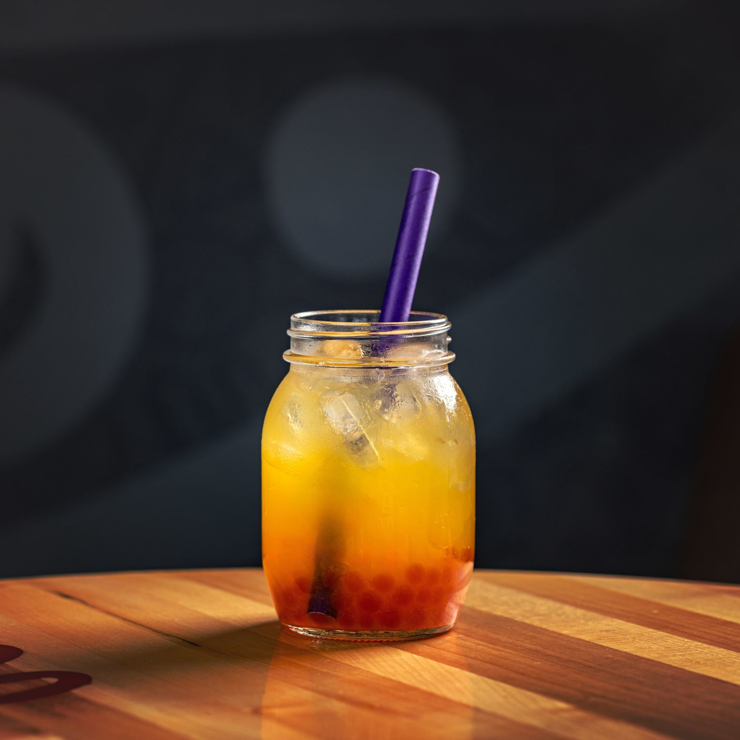 orange juice in a jar with straw